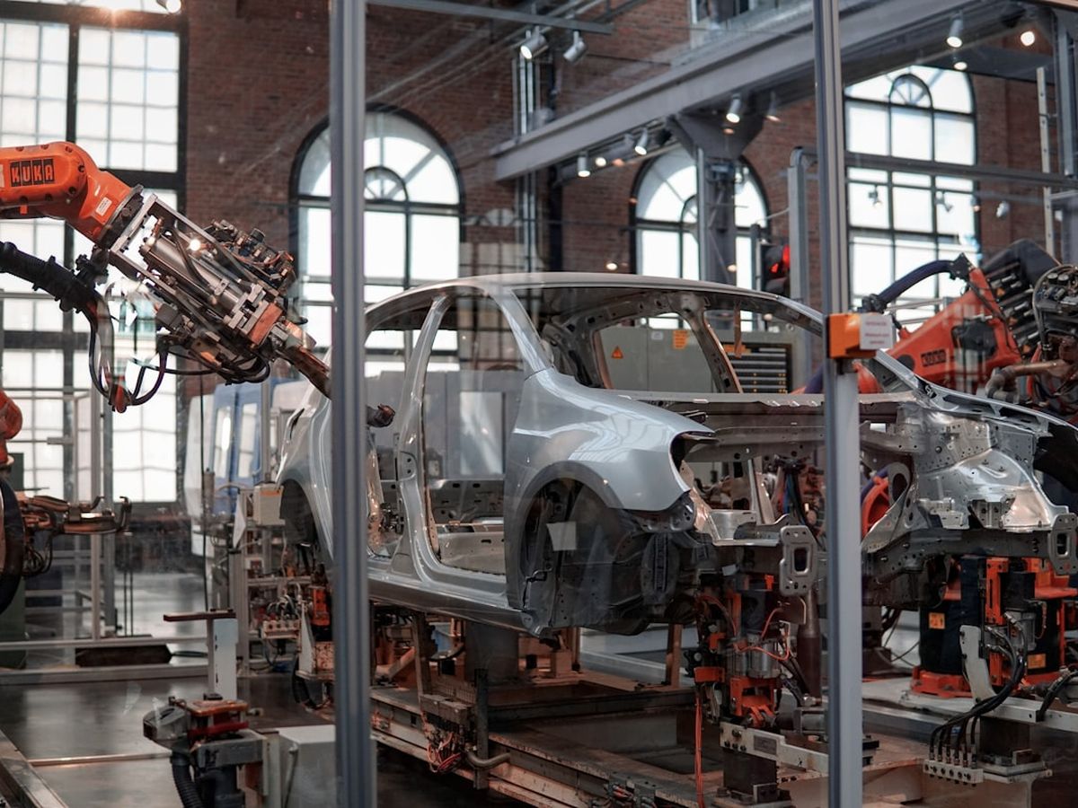 Robotic arms working on an industrial assembly line