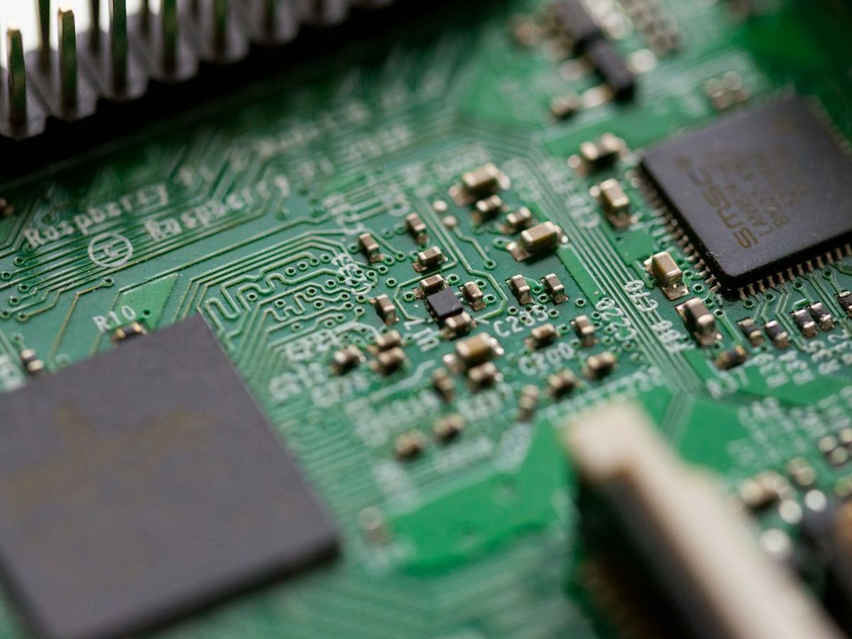 Soldering iron joining components on a circuit board