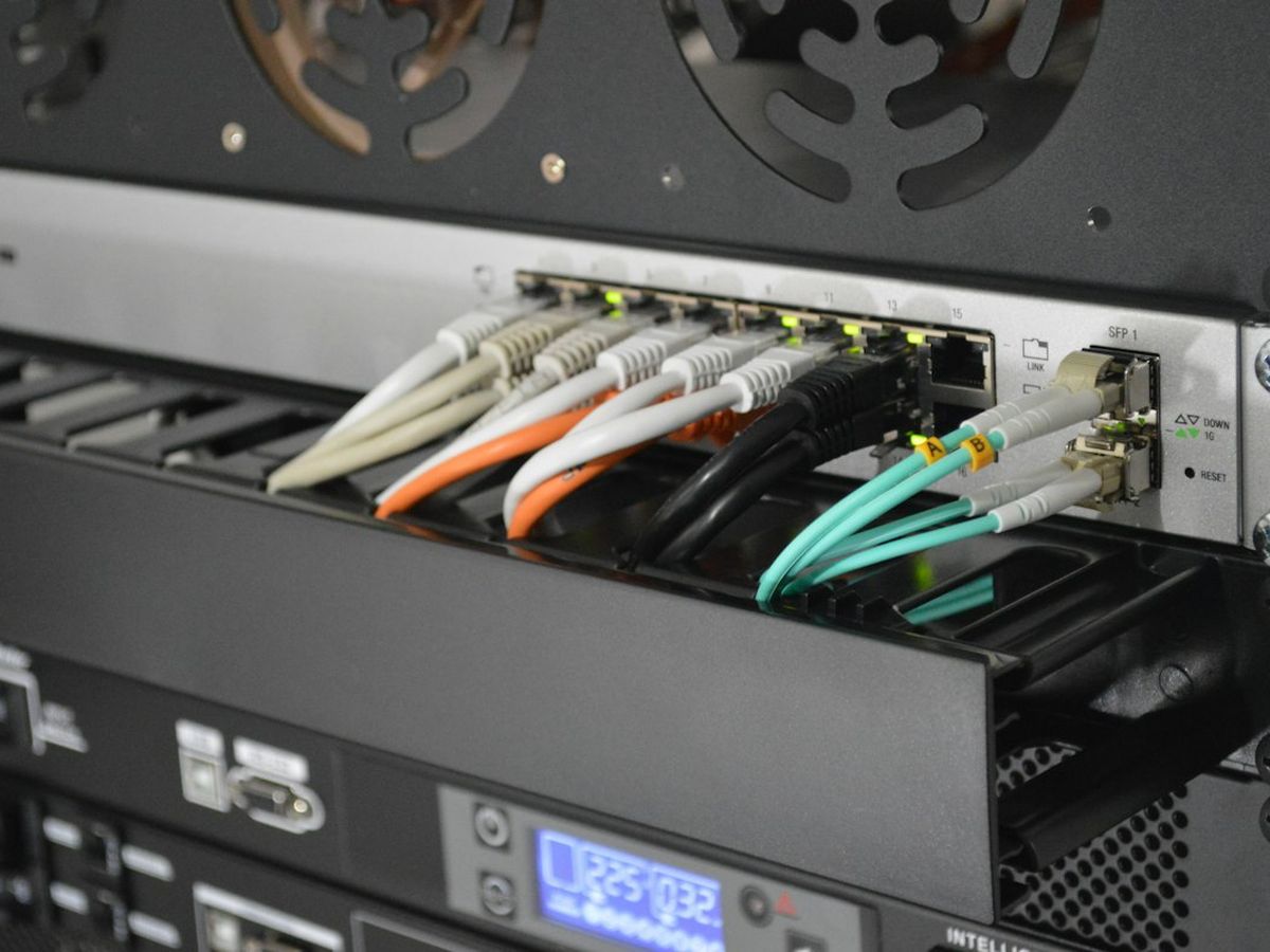 Network cables connected to rack-mounted equipment with a status display